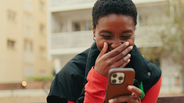 Happy Woman Laughing While Looking At Phone
