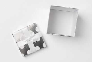 Open polka dot gift box on white background, top view