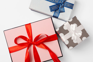 Gift boxes of different sizes and shapes on a white background, top view, close up