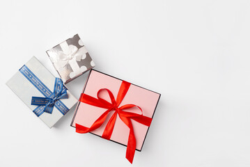 Gift boxes of different sizes and shapes on a white background, top view, copy space