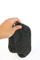 Obraz premium hand holding socks isolated on white background