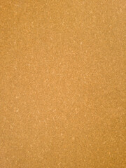 Brown leatherboard sheet texture, even surface used as backing material for leather goods, top view.