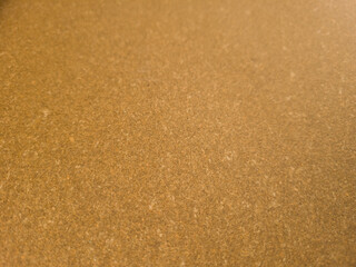 Brown leatherboard sheet texture, even surface used as backing material for leather goods, top view.