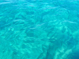 Crystal-clear blue waters of the Tyrrhenian Sea along the coast of Calabria, southern Italy. The tranquil Mediterranean vibrant turquoise hues, natural light, and a serene summer atmosphere, evoking