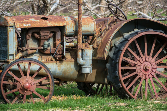Canada, BC, Keremeos.  Rusted old tractor in farm field