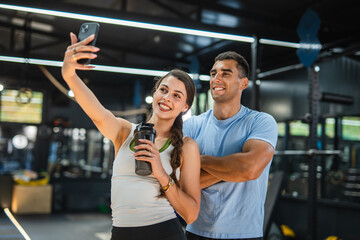 sports man and woman couple, friends take a self portrait at gym