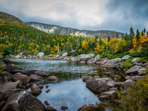Chimney Pond trail hike at Baxter State Park, Maine, with peak fall foliage on an overcast cloudy day