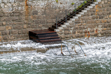 Steep stairs outside on old building facade wall on seaside coast