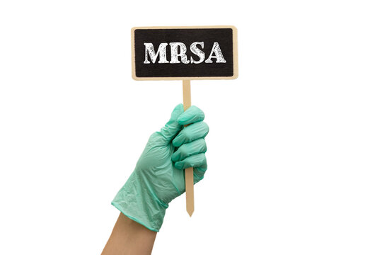 Doctor's hands in blue gloves shows the word MRSA methicillin-resistant Staphylococcus aureus. Medical concept.