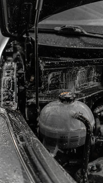 engine and engine compartment of a car during washing. foam applied. car wash, detailing studio