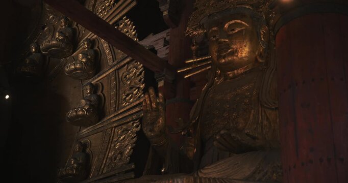 Ancient Buddhist statues inside old Japanese castle - panning shot