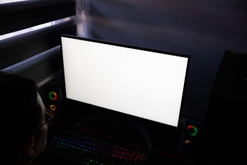 High-angle mockup of a computer screen display ready for custom design content, A PC monitor with a blank white screen at a professional workstation