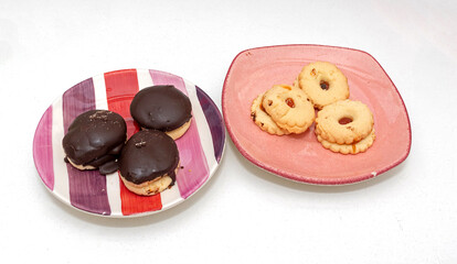Sweet cookies dessert in ceramic plates isolated on white	