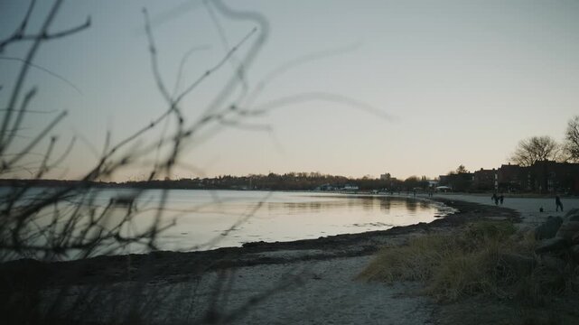 Sunset at the beach in Eckernf&ouml;rde Beach. Warm evening light over sand and calm water creates a peaceful coastal atmosphere in northern Germany.