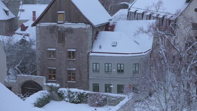 Tilt up view of snow-covered medieval houses in Visby, Gotland