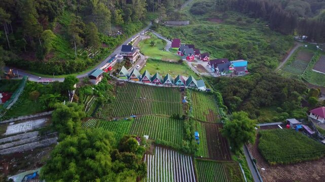 Aerial view of Berastagi town shrouded in thick morning mist and fog with mountain landscape, North Sumatra, Indonesia