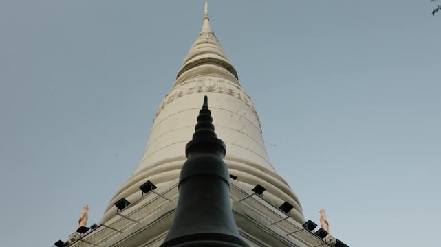Upward view of white stupa and dark finial in Phnom Penh Cambodia