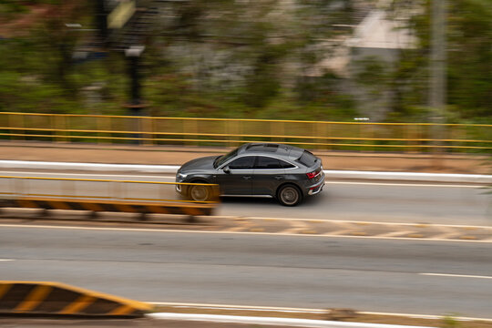 Gray Audi Q5 Sportback in movement, Luxury SUV driving fast on highway with cinematic motion blur