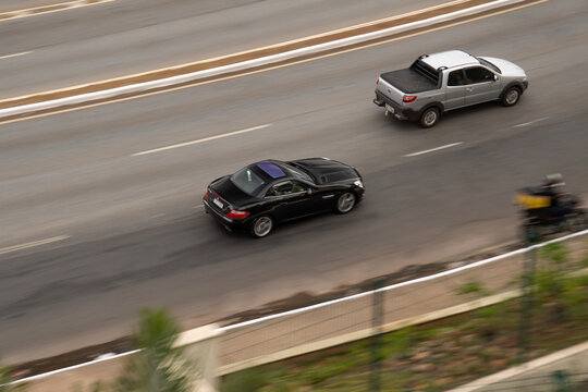 Black Mercedes-Benz SLK panning shot, Luxury convertible sportscar cruising highway