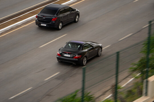 Black Mercedes-Benz SLK panning shot, Luxury convertible sportscar cruising highway
