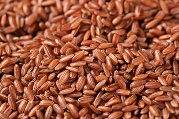 closeup of raw red rice grains background