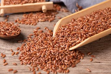 closeup of raw red rice grains on table