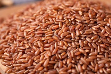 closeup of raw red rice grains background