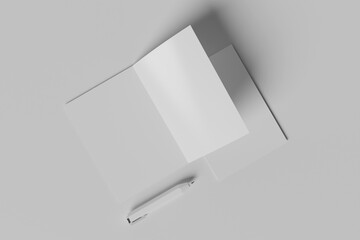 blank bi-fold brochure on grey background with pen
