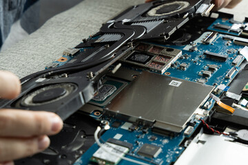 Fototapeta premium Repairing a Laptop and Replacing the Cooling System at a Workbench in a Tech Shop