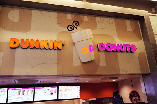 Dunkin' Donuts store front brand logo coloring and banner at airport store in Dallas-Fort Worth, Texas locaiton