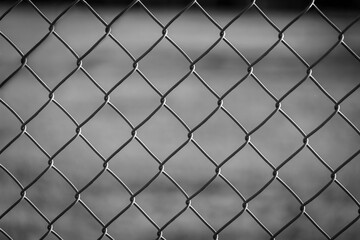 Fototapeta premium Chain link fence in black and white on a sunny day