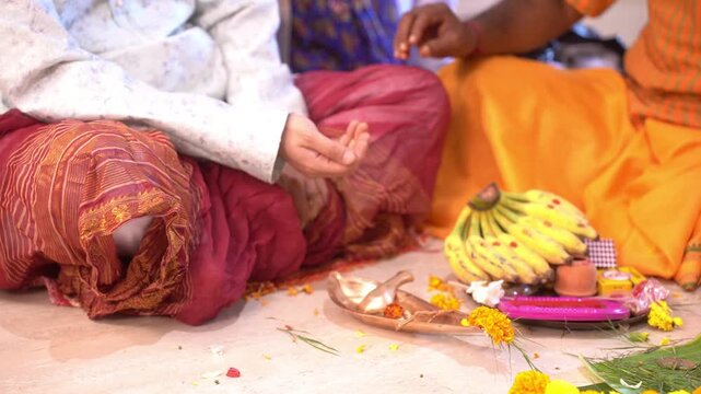 A Hindu man performing a yagna ritual with a Brahmin in the Indian style