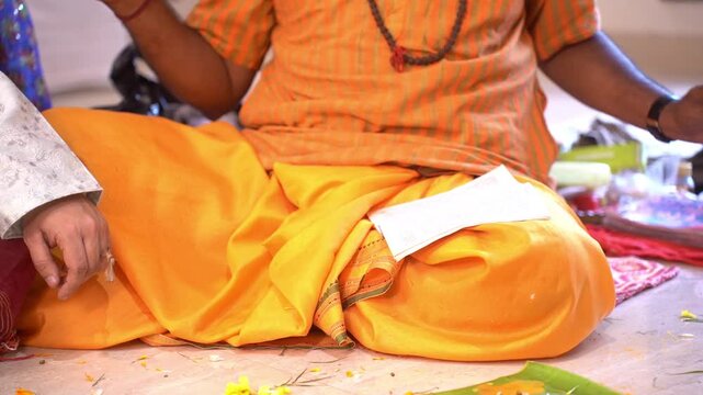 Hindu brahmin performing puja for an Indian festival in rice ceremony event