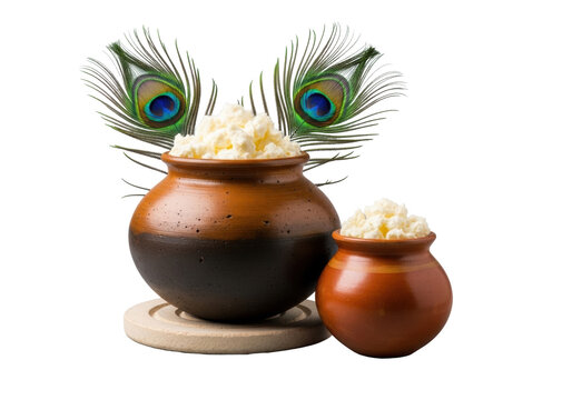 large dark brown matka and orange handi earthenware pots brimming with creamy white homemade butter on a stone trivet, featuring a peacock feather, isolated on gray. Concept of authentic indian