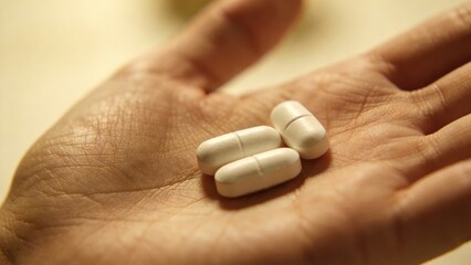 Close up of pills in human hand,medical treatment concept,healthcare medication,dosage and pharmaceutical therapy,illustrating medicine use,safety and health responsibility