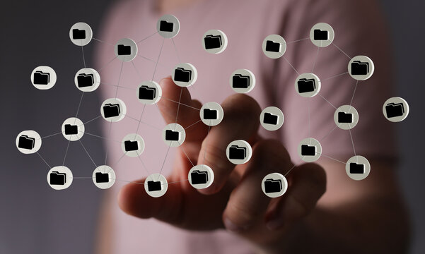 Hand interacting with digital network of folders. Conceptual image for data storage, security, and cloud comput
