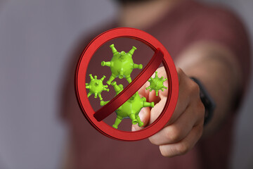 Stop coronavirus concept. Hand with the stop virus symbol,  illustration of virus, preventing the...
