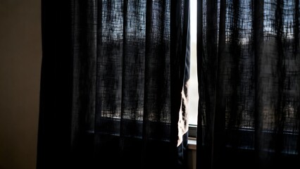 WindowWithDarkCurtainsOpenSlightly