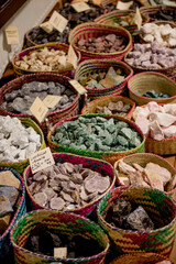 Fototapeta premium Giethoorn, Netherlands, April 08 2018: A vibrant display of colorful gemstones and crystals in woven baskets at a local shop