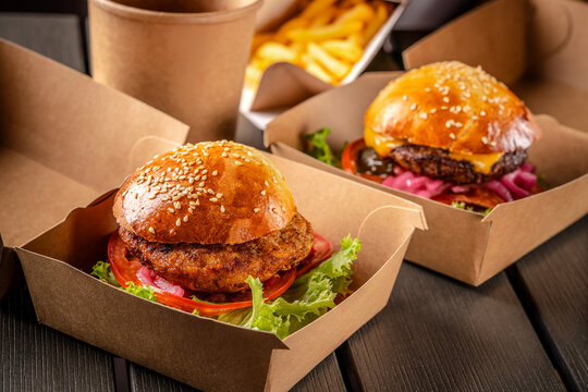 Two fresh burgers in eco takeaway packaging
