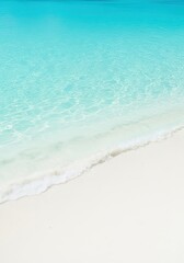 Clear turquoise ocean water gently lapping onto pristine white sandy beach under bright sunlight, creating a peaceful tropical scene, blue, copy space, surf