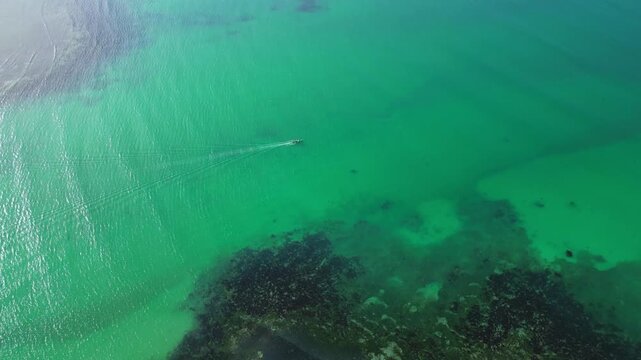 High aerial orbit revealing Tondol Beach sandbar, shallow turquoise water, wide shoreline, and peaceful tropical setting in Anda Pangasinan.