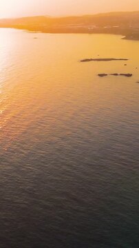 Vertical video. Vertical video. Avsallar, Alanya, Turkey. Aerial view of scenic coastline with beaches, forests, mountains and bays in warm sunset with pink tones. Aerial View. Rich colors. Rich colo