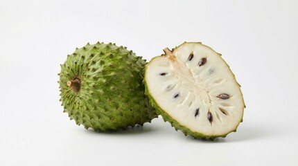 Whole and halved soursop fruit displaying its spiky green exterior and creamy white flesh with dark seeds