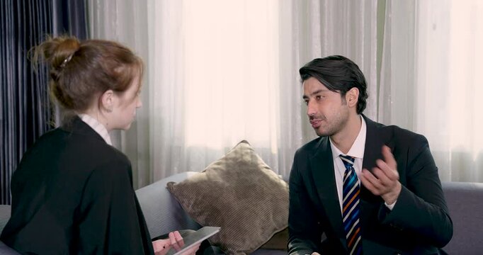 Asian businessman giving business advice to young female executive during lounge meeting sharing ideas and planning business strategy with teamwork and leadership collaboration