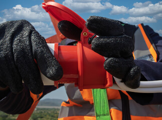 Aerial View of High-Voltage Technician Connecting Power on Telecommunications Tower