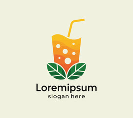 A glass of orange juice with a straw and green leaves underneath yellow