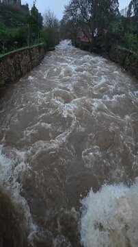 Vertical shot of strong river current during flooding event