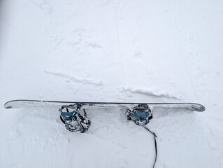 Top-down shot of snowboard equipment on the ground during winter in Japan