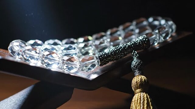Sparkling Crystal Tasbih Resting on Wooden Rehal - Islamic Worship and Contemplation Focus